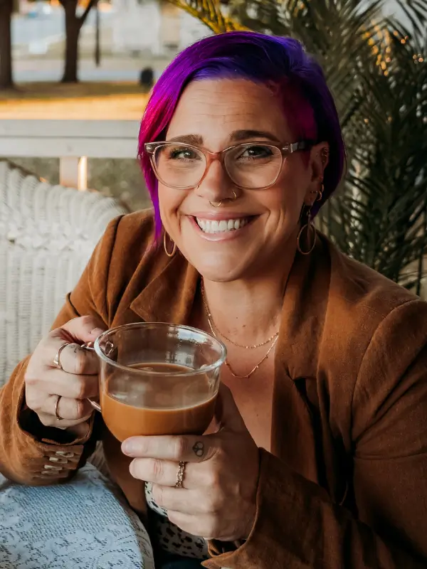 Dr. Emma Church - holistic trauma recovery - woman with pink and purple hair sipping a latte